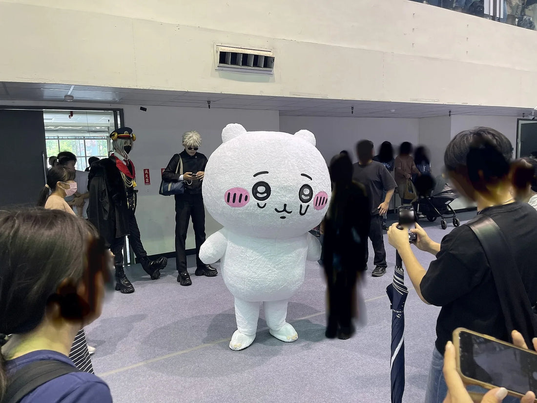 A life-size Chiikawa, the round white character with pink cheeks and small round ears, standing in a crowd at an anime festival in Hsinchu, Taiwan