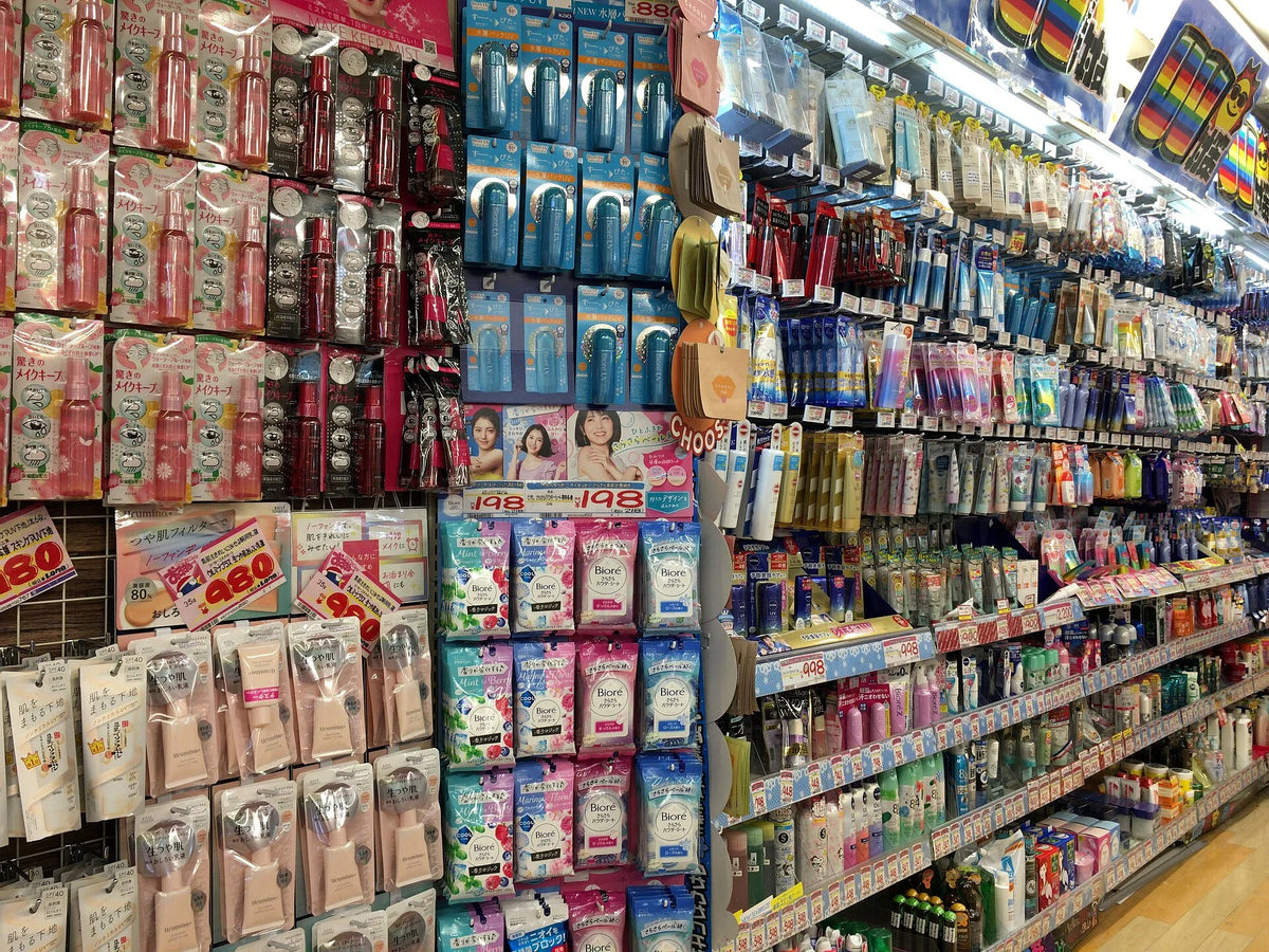 Inside a Don Quijote in Shibuya — shelves packed to the ceiling with hand-written yellow price signs
