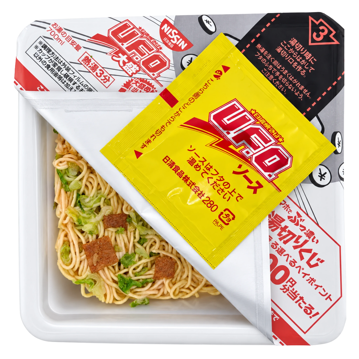 Nissin UFO Yakisoba Large opened, showing the dried noodle block with cabbage and pork and the sauce sachet resting on the peeled-back lid